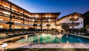 an exterior view of a building with a swimming pool at Hotel Saltauserhof in Saltusio