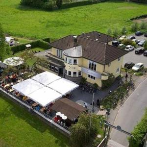 an overhead view of a large house with a white tent at Aggerschlösschen in Wahlscheid