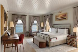 a bedroom with a large bed and a desk and a desk at Six Senses Kocatas Mansions in Istanbul