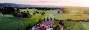 an aerial view of a house in a green field at Locanda Ca' Matilde in Quattro Castella