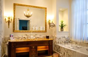 a bathroom with a tub and a sink and a mirror at Four Seasons Hotel Firenze in Florence