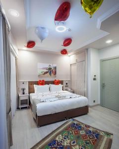 a bedroom with a large bed with red decorations on the ceiling at OBAHAN HOTEL-Special Class in Istanbul
