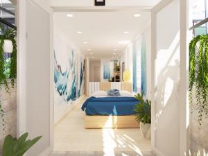 ハノイにあるGraffiti Hotelの白い部屋に青いベッドが備わるベッドルーム1室