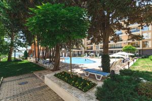 a swimming pool in front of a large building at Olympia Beach Complex in Ravda