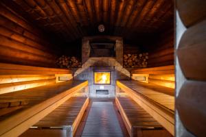 a inside view of a sauna with a fire in it at Waldhotel Tannenhäuschen in Wesel