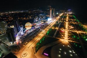 an aerial view of a city at night at Orange Sky Apartments Beach Tower in Batumi