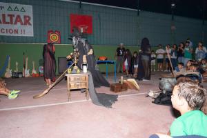 a man dressed as a wizard standing in a stage at Camping Baltar in Portonovo