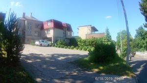 a white car parked in front of a building at Family in Kaunas