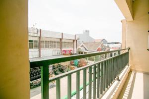 a balcony with a view of a train yard at Grand Azizah Makassar RedPartner in Makassar