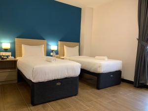 Postel nebo postele na pokoji v ubytování ZONE Hotels, Telok Panglima Garang