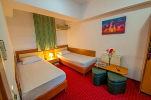 Postel nebo postele na pokoji v ubytování Hotel Sir Orhideea