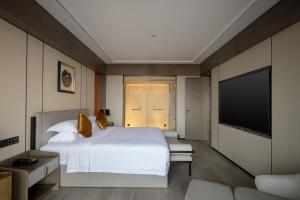 Postel nebo postele na pokoji v ubytování Tian Yi International Hotel 天艺国际酒店