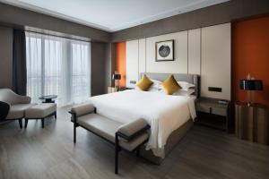 Postel nebo postele na pokoji v ubytování Tian Yi International Hotel 天艺国际酒店