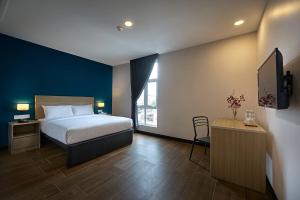 Postel nebo postele na pokoji v ubytování ZONE Hotels, Telok Panglima Garang