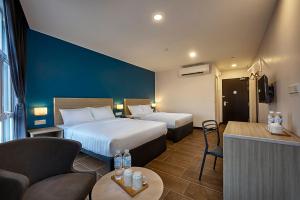 Postel nebo postele na pokoji v ubytování ZONE Hotels, Telok Panglima Garang