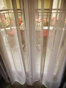 a group of windows with white curtains in a room at Hotel Maravillas del Mundo in Calpe