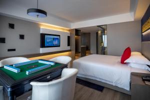 Postel nebo postele na pokoji v ubytování Tian Yi International Hotel 天艺国际酒店