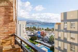 a balcony with a view of the ocean and buildings at A&N Paseo de Larios in Torre del Mar