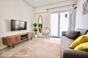 a living room with a tv and a couch at Akicity Marques Pearl in Lisbon