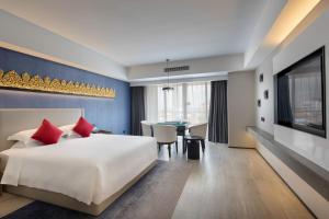 Postel nebo postele na pokoji v ubytování Tian Yi International Hotel 天艺国际酒店