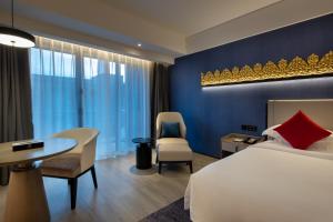 Postel nebo postele na pokoji v ubytování Tian Yi International Hotel 天艺国际酒店
