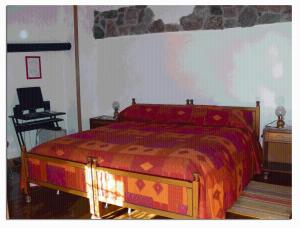 a bedroom with a bed and a piano in it at B&B Baita Evelina in San Giorio