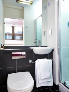 a bathroom with a white toilet and a sink at Conference Aston Hotel - Birmingham City in Birmingham +37 photos