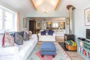 a living room with a white couch and a table at The Pink House, Thorpeness in Thorpeness