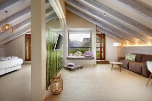 a living room with a couch and a large window at Hotel Boutique Mediodía & Apartments in Plan