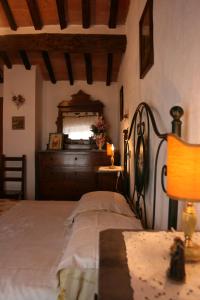 a bedroom with a bed and a window and a lamp at PODERE CAPANNE in Sinalunga
