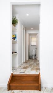 a hallway with a toilet and a wooden floor at Warburton Digs in Warburton