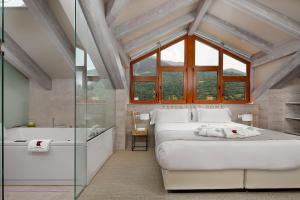 a bedroom with a large bed and a bath tub at Hotel Boutique Mediodía & Apartments in Plan +52 photos