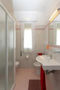 a bathroom with a sink and a toilet and a shower at Appartamenti Bedin, JESOLO LIDO in Lido di Jesolo