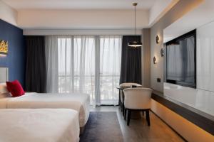 Postel nebo postele na pokoji v ubytování Tian Yi International Hotel 天艺国际酒店
