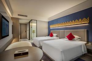 Postel nebo postele na pokoji v ubytování Tian Yi International Hotel 天艺国际酒店