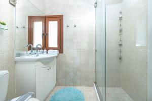 a bathroom with a sink and a shower at Villa Ligaria, Lygaria in Agia Pelagia