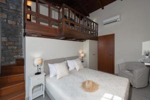 a bedroom with a large bed with a wooden ceiling at Villa Ligaria, Lygaria in Agia Pelagia