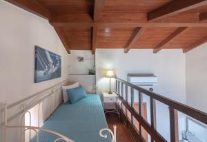 a room with a staircase with a blue couch at Villa Ligaria, Lygaria in Agia Pelagia