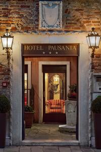a hotel lobby with a hotel roseania sign on the door at Hotel Pausania in Venice