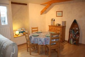 a dining room with a table and some chairs at Les Petits Galets appartement DUPLEX in Fécamp +11 photos