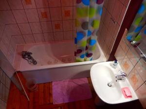 a bathroom with a tub and a sink and a shower at Les Petits Galets appartement DUPLEX in Fécamp