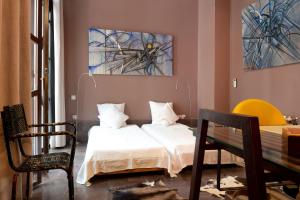 a bedroom with a bed and a table and chairs at Dar d'Art in Marrakesh +37 photos