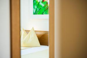 a pair of white pillows sitting on top of a bed at ODELYA - Stadthotel im Park in Basel