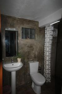 a bathroom with a toilet and a sink at Mahaweli Shades in Kandy +180 photos