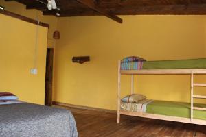 a bedroom with two bunk beds and a yellow wall at Yateí-house in El Soberbio