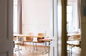 a dining room with a table and chairs at ODELYA - Stadthotel im Park in Basel