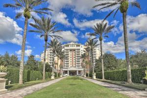 a building with palm trees in front of it at Luxury 3BR Reunion Resort Condo Near Disney Golf & Pools in Kissimmee