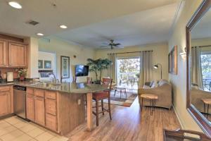 a kitchen and living room with a large island at Luxury 3BR Reunion Resort Condo Near Disney Golf & Pools in Kissimmee