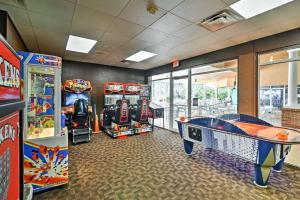 a gaming room with arcade games and a pool table at Luxury 3BR Reunion Resort Condo Near Disney Golf & Pools in Kissimmee