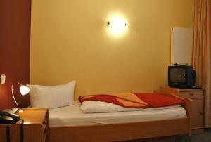 Postel nebo postele na pokoji v ubytování Dünenhotel Borkum